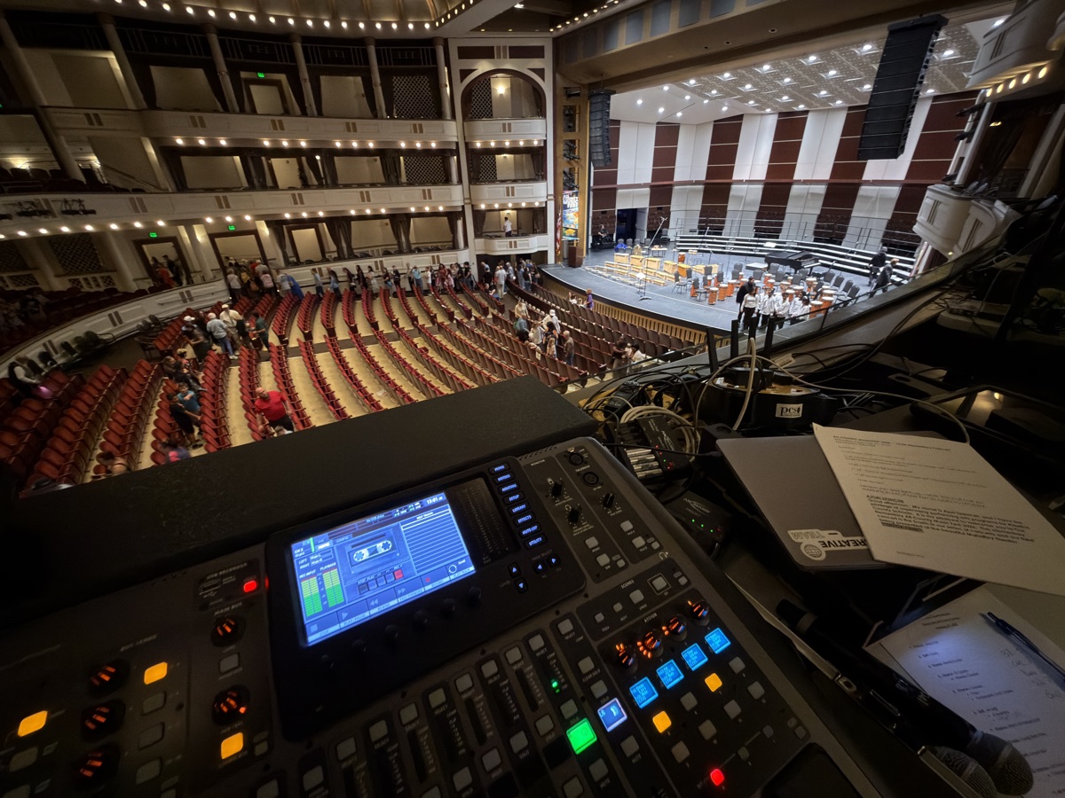 Mixing console on a concert hall balcony as the audience arrives